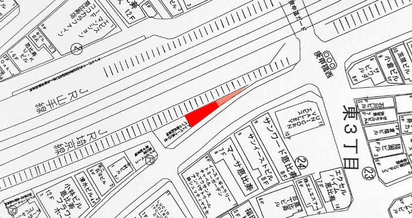 A narrow, triangular site along the railroad tracks.